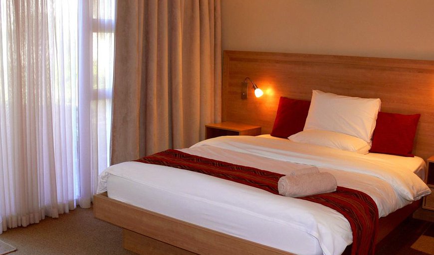 Deluxe Room: Deluxe Room - Each room has direct access to the garden and pool and is furnished with an extra length queen-size bed with an en-suite bathroom containing a shower.