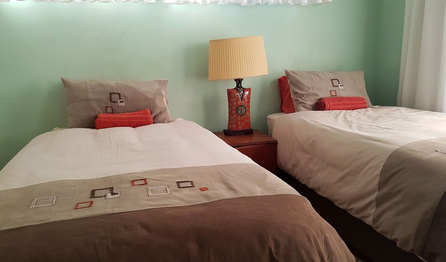 The Cottage: Main House Bedrooms - Each bedroom is furnished with two single beds and offers air-conditioning, a TV, a wardrobe, a reading table with a chair and coffee/tea making facilities.
