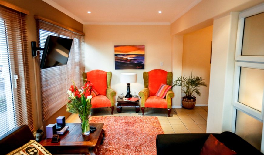 Strelitza Luxury Suite: This Luxury Suite embodies the Secret Garden Guesthouse theme of Afro-chic elegance with features such as a leather sleeper couch, a rich plush carpet and retro wingedback chairs.