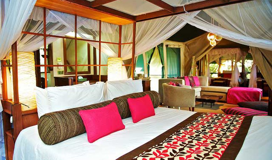 Luxury Tented Camp - The spacious tents offer 4-poster beds that are either a queen size bed or two twin beds and an en-suite bathroom. Luxury Tented Camp - The spacious tents offer 4-poster beds that are either a queen size bed or two twin beds and an en-suite bathroom.