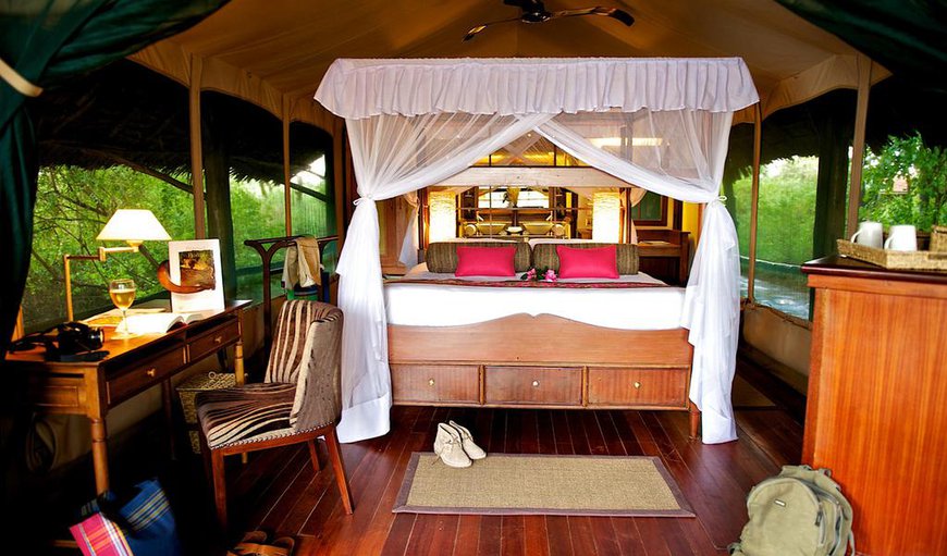 Luxury Tented Camp - The spacious tents offer 4-poster beds that are either a queen size bed or two twin beds and an en-suite bathroom. Luxury Tented Camp - The spacious tents offer 4-poster beds that are either a queen size bed or two twin beds and an en-suite bathroom.