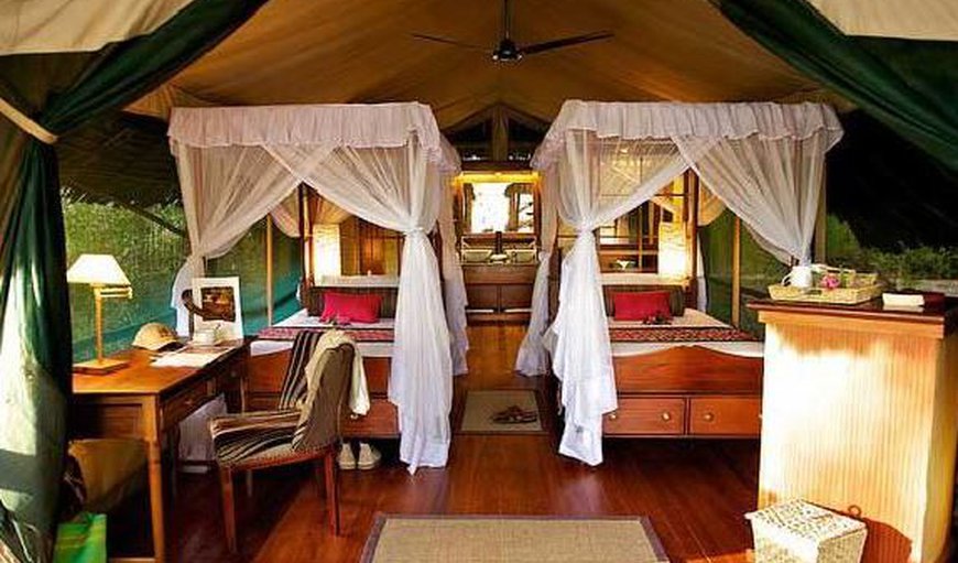 Luxury Tented Camp - The spacious tents offer 4-poster beds that are either a queen size bed or two twin beds and an en-suite bathroom. Luxury Tented Camp - The spacious tents offer 4-poster beds that are either a queen size bed or two twin beds and an en-suite bathroom.