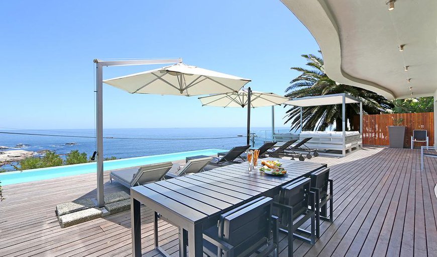 The villa features a wooden deck with a swimming pool, sun loungers, outdoor seating area and outdoor dining area. The villa features a wooden deck with a swimming pool, sun loungers, outdoor seating area and outdoor dining area.