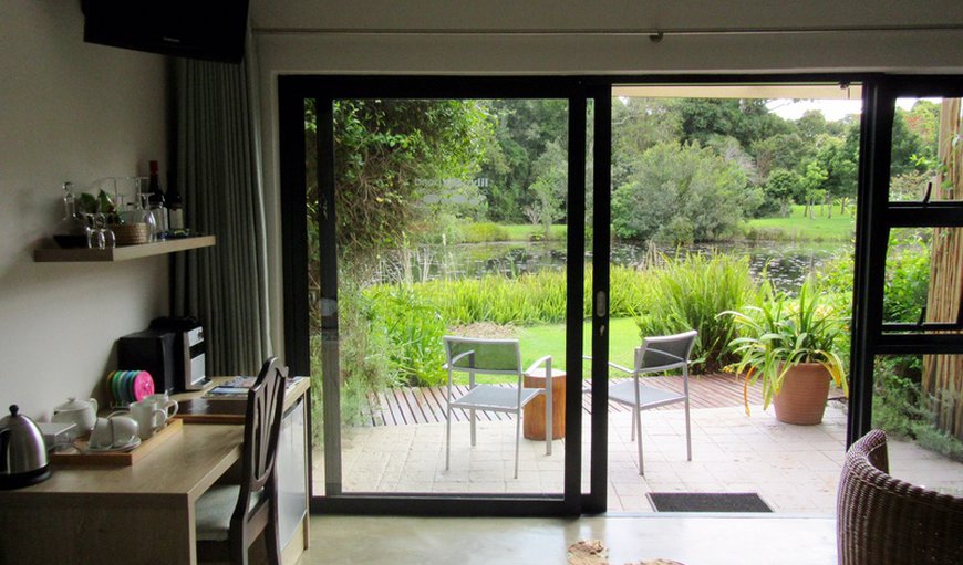 Garden En Suite Room with a TV, table and chairs.