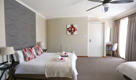 Self-Catering Room 6: One double and one single bed with a kitchenette and an en-suite bathroom with a shower. The room includes an air- conditioning, TV, free wifi, coffee/tea station, microwave, cooking utensils, and crockery with a view overlooking Tygerberg Nature Reserve.