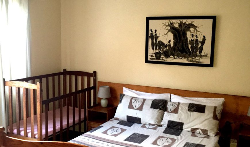 Hubbly Bubbly House: Bedroom with a double bed and cot.