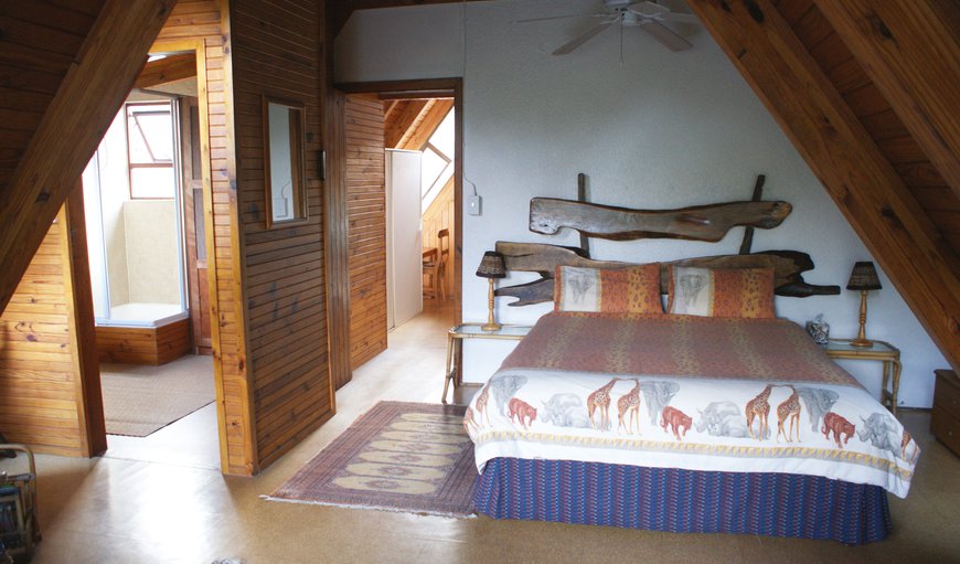 Nectar Cottage: Master bedroom with private sitting area, deck and en-suite bathroom. Overhead fan.