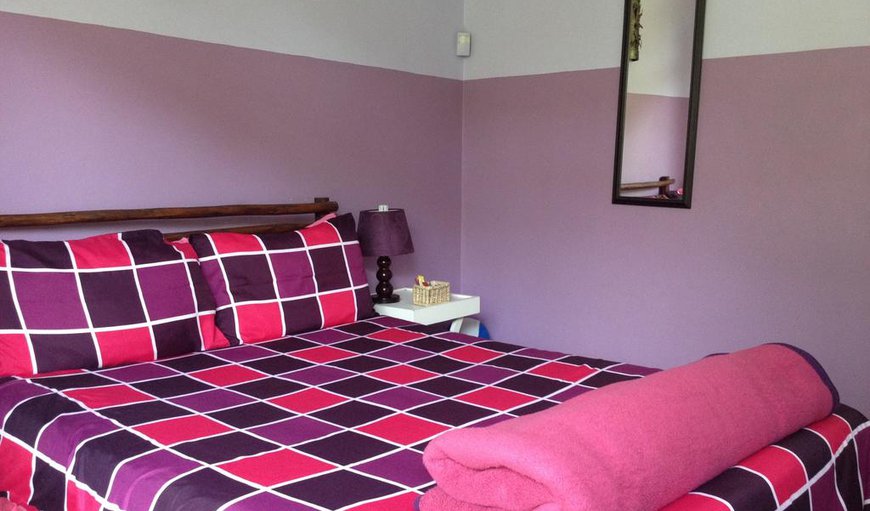 Double Room (Purple): Double Room (Purple) - This bedroom is comfortably furnished with a double bed and shares a bathroom.