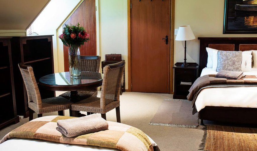 The large family room is furnished with a king size bed, two single beds, a table with chairs and a bathroom. The large family room is furnished with a king size bed, two single beds, a table with chairs and a bathroom.