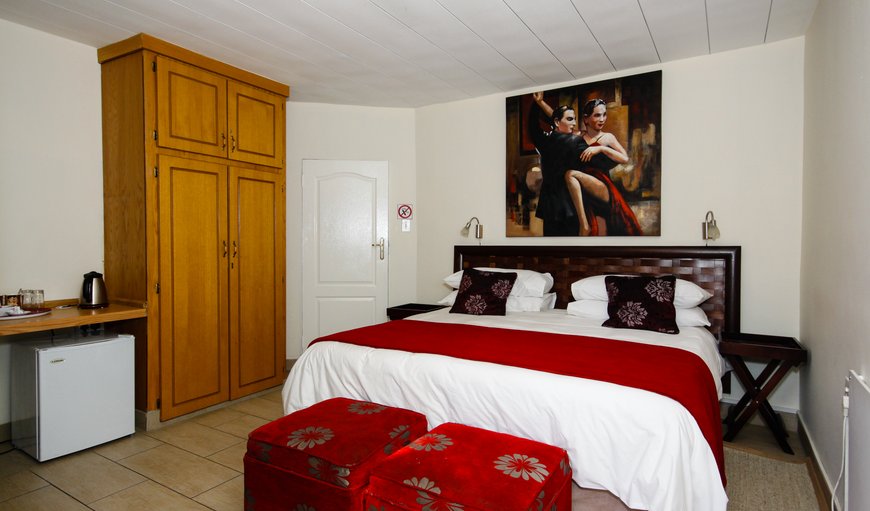 Passion: This room is equipped with a King sized bed, ensuring a comfortable stay. The room has a en-suite bathroom with a shower. Amenities available are tea and coffee facilities, a bar fridge, flatscreen TV, DSTV, heater, towels and linen.
