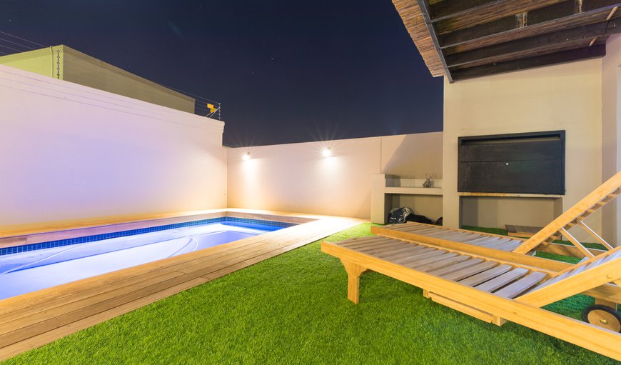 BBQ & pool area with artificial grass
