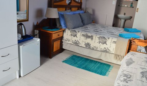 N1double room en suite: The N1 triple ensuite is situated upstairs and opens onto a balcony. It has a double bed and a single bed with an en suite shower toilet and basin.
There is a tv, mini fridge, hair dryer, cupboard with drawers and tea& coffee making facilityn the room.