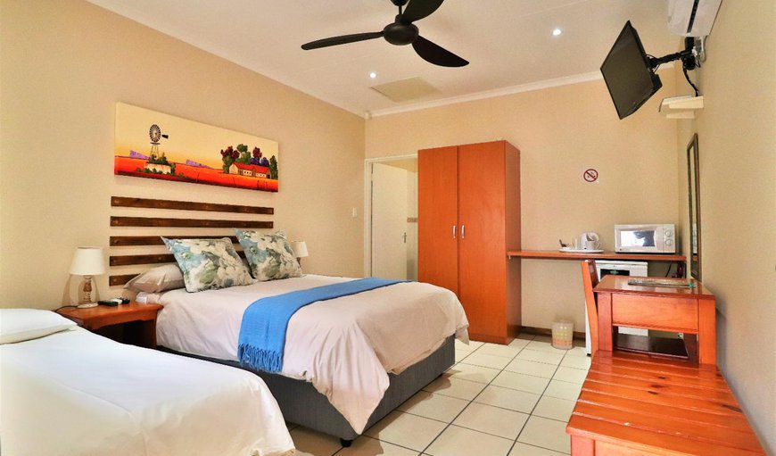 Twin Room or Double Room: Twin Room or Double Room - This room contains one double bed and one single bed with a TV with selected DSTV channels, a bar fridge, microwave and tea/coffee making facilities.
