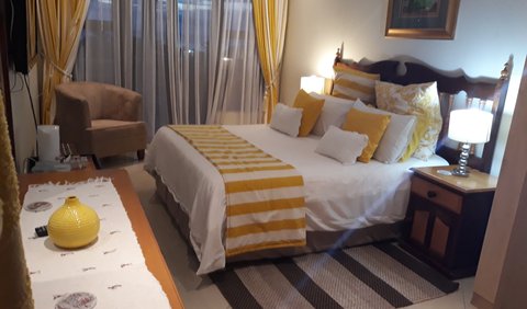 Upstairs Yellow Room: The Sunshine room has a Queen bed and dresser. The room has a balcony overlooking the garden, river and sea. Very spacious with lots of packing space. It shares a bathroom with the Anchor room.