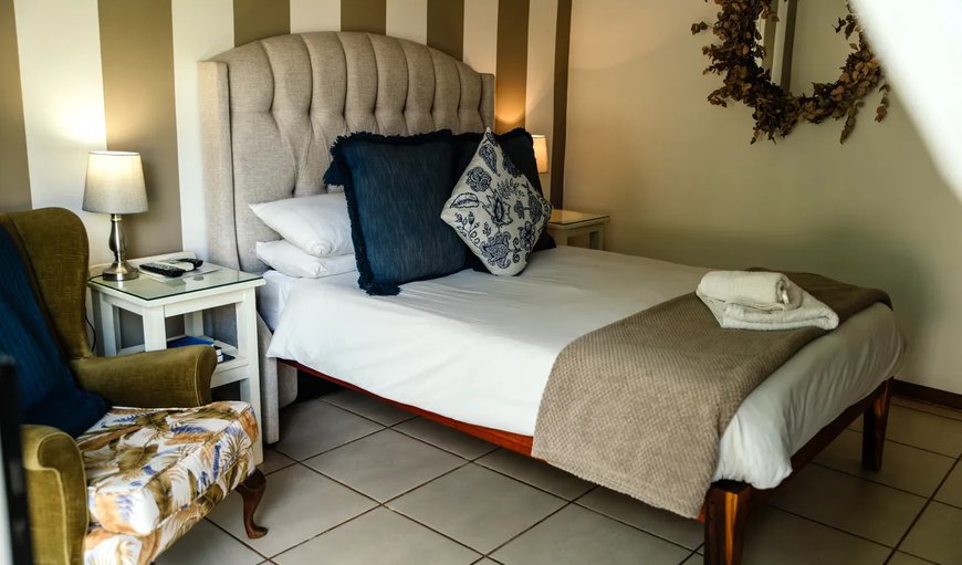 Double Rooms - Our double rooms consist of a double bed, a TV with DStv, a bar fridge, ameneties, towels, an air conditioner and a hair dryer.