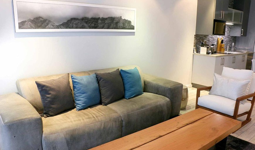 One Bedroom - Harbour view apartment: The lounge area is tastefully furnished with comfortable couches and has a flat screen TV.