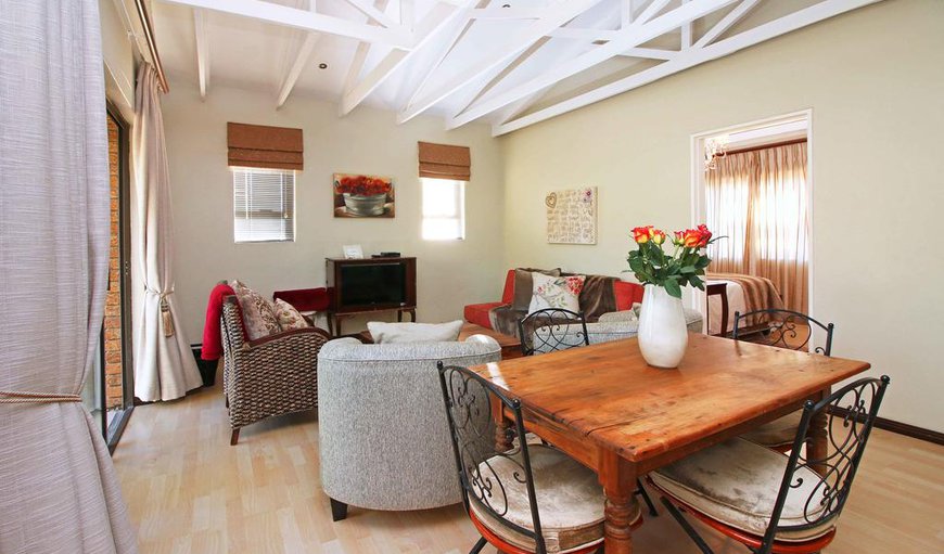 One bedroom apartment with balcony - The living room has a TV with DSTV, a double sofa bed for children and a dining table seating four in total. One bedroom apartment with balcony - The living room has a TV with DSTV, a double sofa bed for children and a dining table seating four in total.
