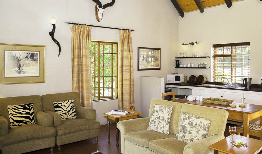 The Zebra Cottage: The Zebra Cottage - The open plan lounge/kitchen area opens out onto the veranda.