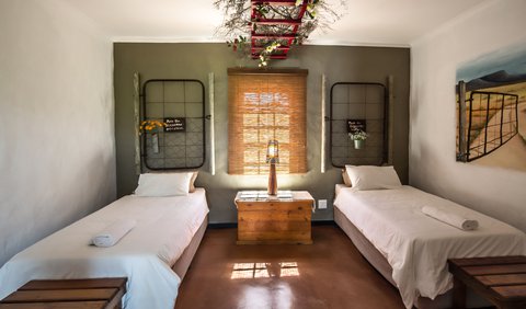 Pinotage: This room is equipped with two single beds, an en-suite bathroom (shower only), a coffee station and fan.  For your sleeping comfort we provide pure cotton percale bedding and towels.  This room has been equipped for the wheelchair-bound holidaymaker.