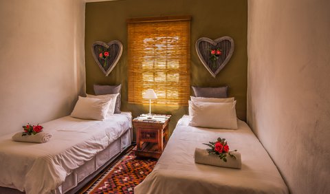 DEW FLOWER: This room is equipped with two single beds, an en-suite bathroom (shower only), a coffee station and fan.  For your sleeping comfort we provide pure cotton percale bedding and towels.