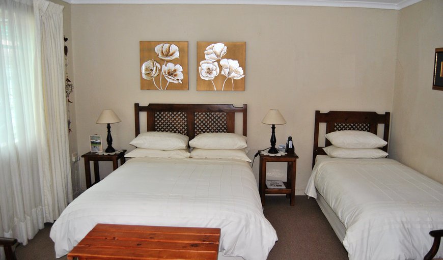 Room 2: Room 2 - This bedroom is comfortably furnished with a double bed and 2 single beds