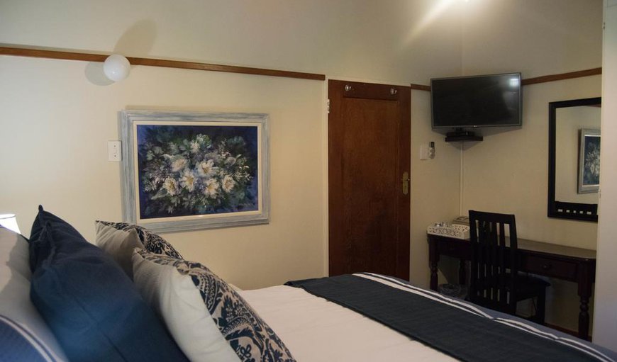 B-Std Double: Blue Room - The room has a queen-size bed and a TV with selected DSTV channels, as well as an en-suite bathroom with a bath.