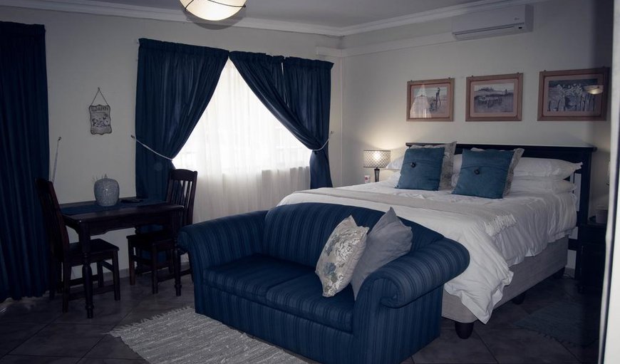 Comfort Double/Twin: Family Room - The room has a king size bed and a sleeper couch for children under 14, as well as a TV with DSTV and an en-suite bathroom with a shower and bath.