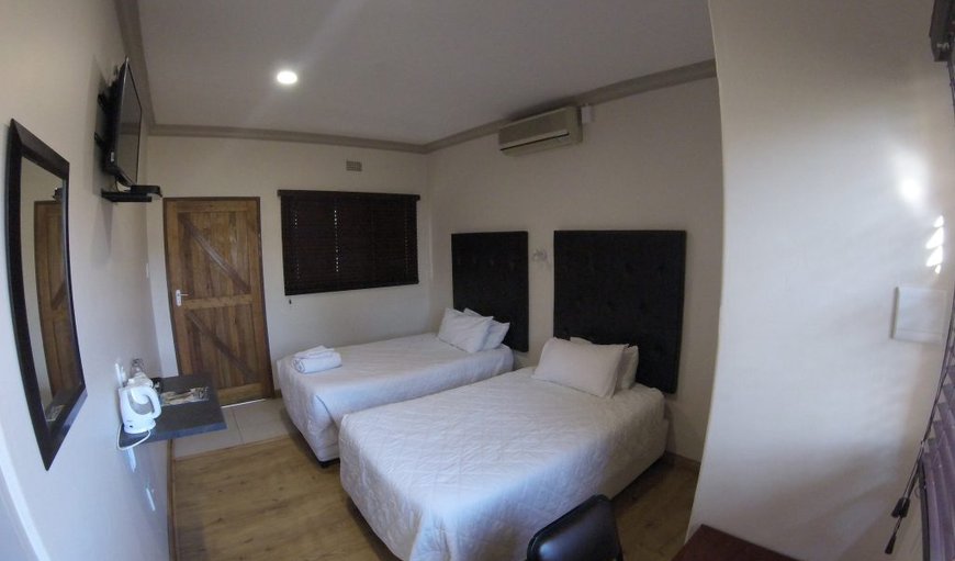 Room 5 - 12: These rooms contain twin three-quarter beds and en-suite bathroom with a bath, and a TV with M-Net and selected DSTV channels.