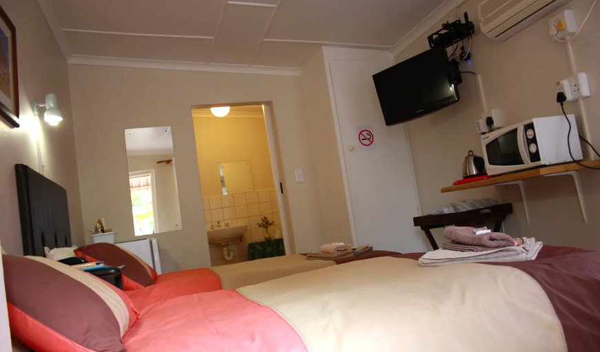 Twin Room: Twin Room - Each room is furnished with two single beds, a TV with DSTV, tea and coffee making facilities, a bar fridge and a microwave.