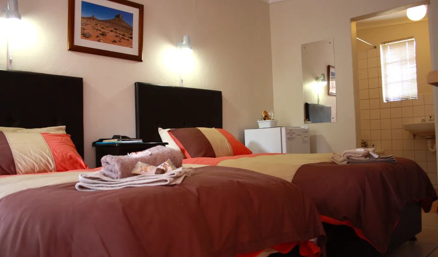 Twin Room: Twin Room - Each room is furnished with two single beds, a TV with DSTV, tea and coffee making facilities, a bar fridge and a microwave.