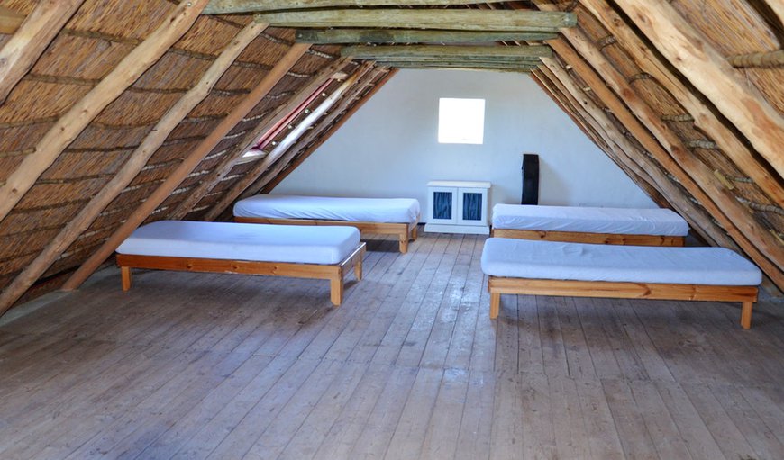 De Mond Cottage - The loft area is furnished with four single beds sleeping an additional four guests. De Mond Cottage - The loft area is furnished with four single beds sleeping an additional four guests.