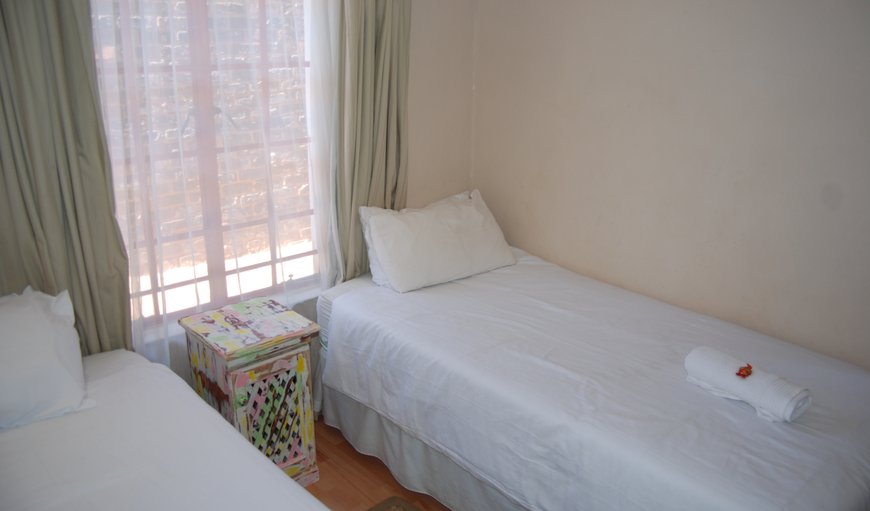 Room 4 - Standard Family Room: Room 4 - Standard Family Room - Second bedroom - 2 single beds and a bunk bed.
