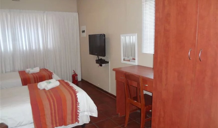 1 Bedroom - 2 Sleeper: 2 Sleeper open plan unit with 2 single beds & a TV with DSTV.