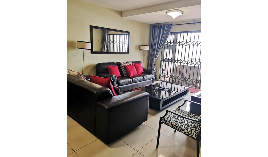 16 isikhulu Apartment: 16 Isikhulu lounge with sliding doors opening up onto balcony