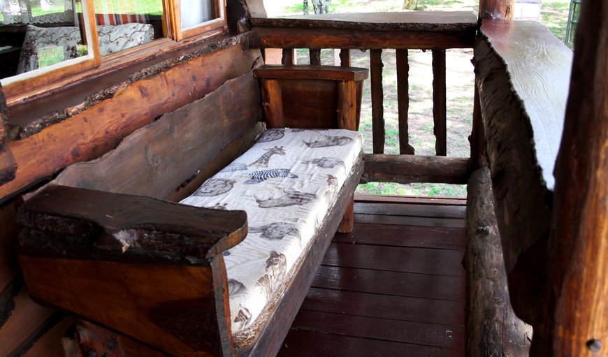 Rustic balcony and quaint bench with a thick cushion for comfortable viewing of the peaceful surroundings Rustic balcony and quaint bench with a thick cushion for comfortable viewing of the peaceful surroundings