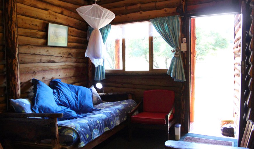 Sleeper couch with mosquito net, downstairs in the open-plan living area, next to the stable door leading onto the balcony Sleeper couch with mosquito net, downstairs in the open-plan living area, next to the stable door leading onto the balcony