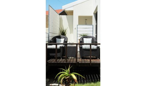 East Room: outdoor shower with a sea view on the deck.