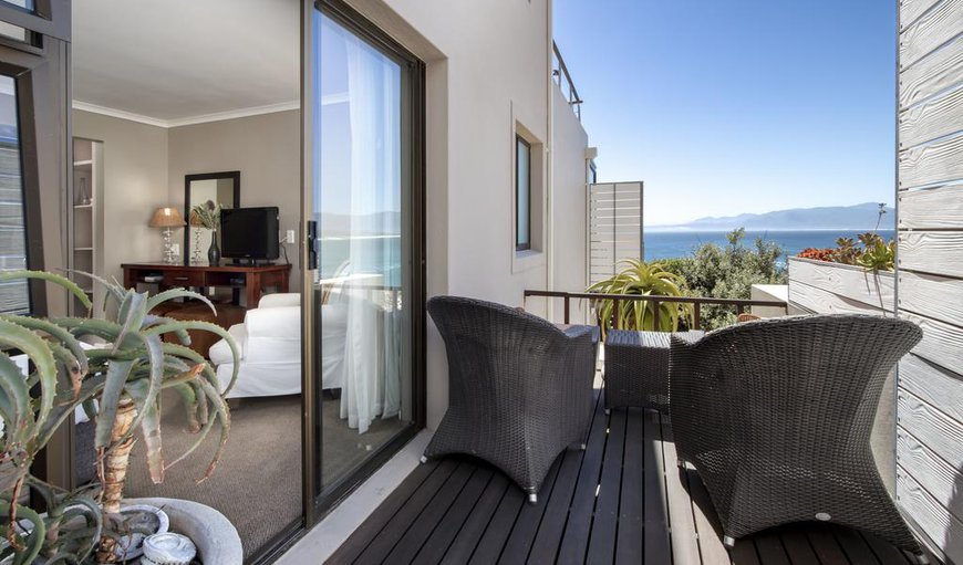 East Room: East Room- The glass sliding doors open onto a wooden deck that overlooks an aloe garden, the sea shore, as well as the Walker Bay Nature Reserve.