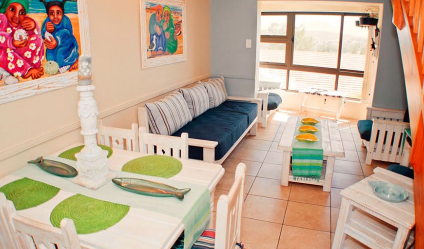 The living area downstairs has an indoor braai with sliding windows and sea views. The is a TV with DStv and a DVD player in this area as well as a six seater dining room area. The living area downstairs has an indoor braai with sliding windows and sea views. The is a TV with DStv and a DVD player in this area as well as a six seater dining room area.