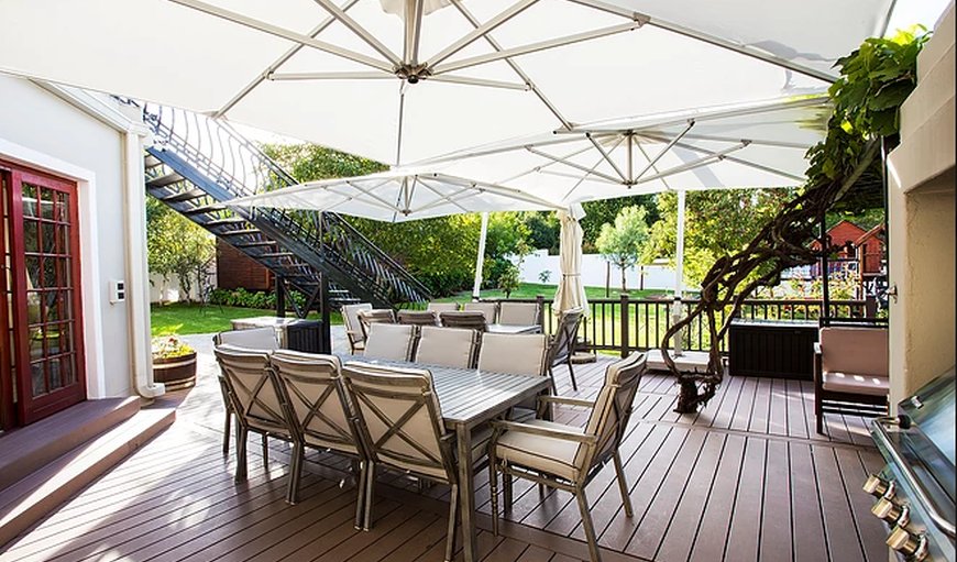 The Browns' Luxury Guest Suites with a table and chairs outside on the deck. in Dullstroom, Mpumalanga, South Africa