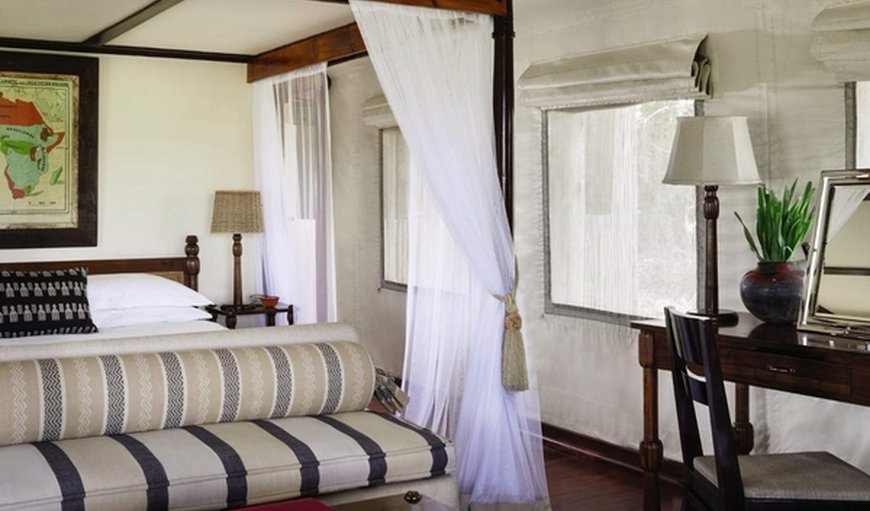 Luxury tented rooms of Savute Elephant Lodge: Luxury Tented Rooms with a double bed, table and a chair.