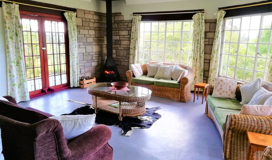 Stormy Hill Country Cottage: Living room with log fire