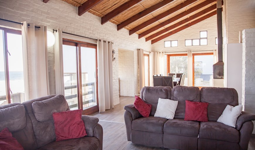 The lounge area is furnished with comfortable couches, a fireplace and a TV with DSTV and sea views. The lounge area is furnished with comfortable couches, a fireplace and a TV with DSTV and sea views.