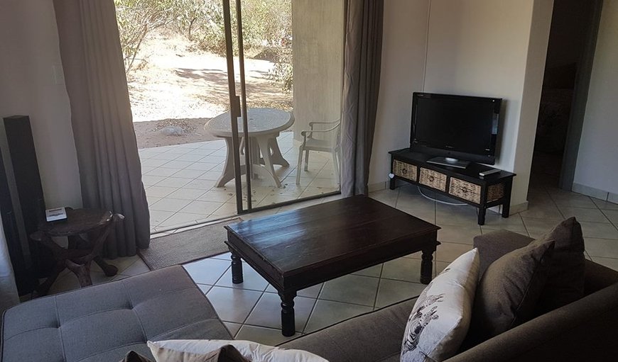 Holiday Home: Umbhandu offers an open plan lounge area with sliding doors leading out onto the veranda.