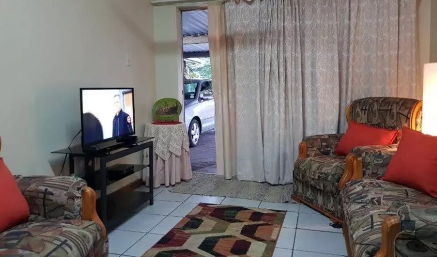 Cassiandra Place Unit 1: Cassiandra Place Self Catering Unit 1: The lounge has a comfy lounge suite and a wall-mounted flat-screen TV with full DStv channels.