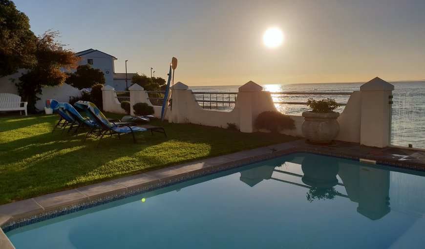 Your private garden with steps leading directly on a quiet beach below.  Grab a paddle ski and enjoy the ocean on calm days. in Gordon's Bay, Western Cape, South Africa