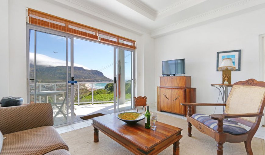 Garden Apartment Fish Hoek Bay: Lounge leading to a balcony with a beautiful view