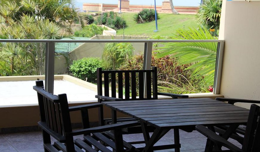 The living area has sliding doors leading out to a furnished balcony with braai facilities