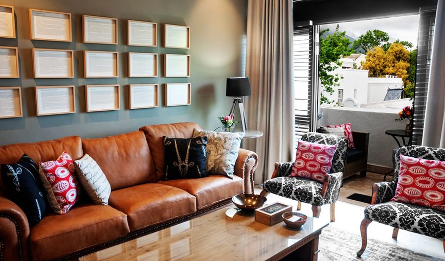 The lounge area is tastefully furnished with comfortable couches and a flat screen TV. in  Stellenbosch Central, Stellenbosch, Western Cape, South Africa
