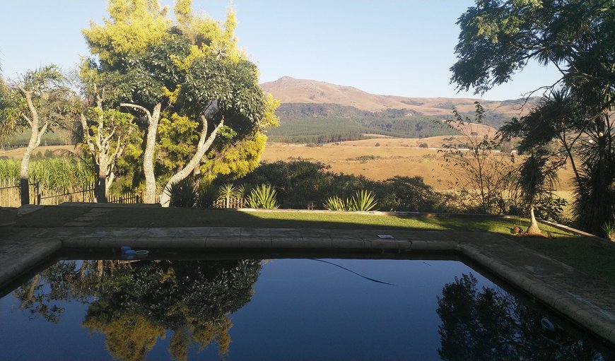 View across pool on garden and mountains